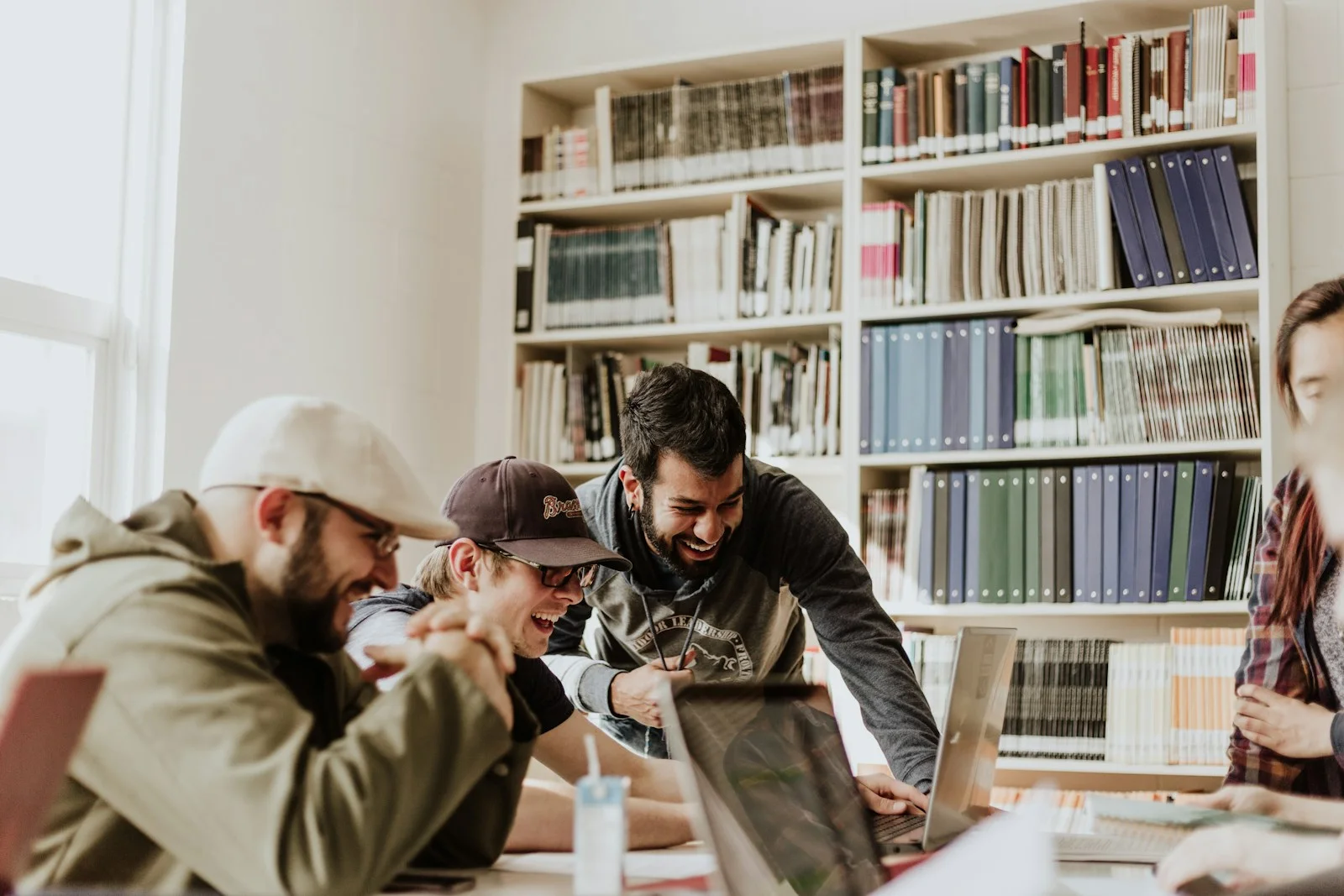 Young adults collaborating around a study table